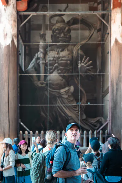 Man looking at the statue of Vajrayaksa at Nandai-mon