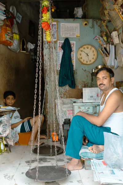 Father and son relaxing in a store with a large balance