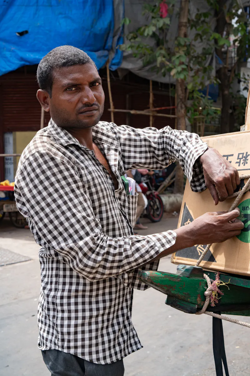 Man attaching a load to a cart