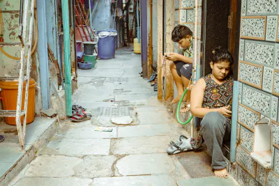 People looking at their phones in an alley