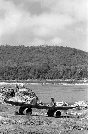 Two persons sitting on landed boat