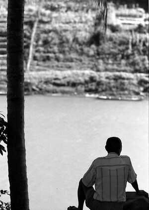 Man looking at Nam Khan river