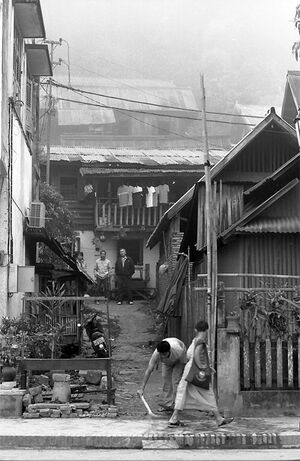 Young Buddhist monk wallking sidewalk