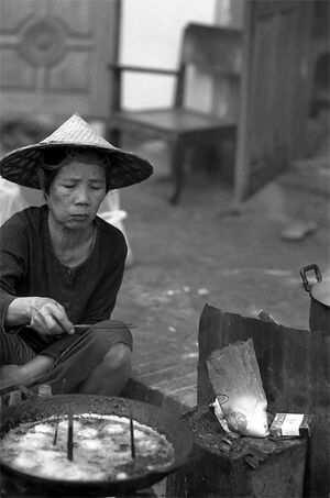 Woman frying dumplings