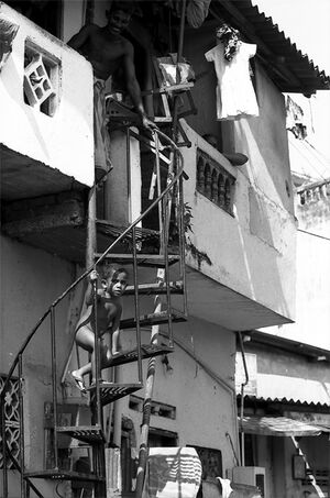 Naked boy climbing up spiral stairway