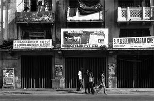 Young woman with saree walking in front of old building