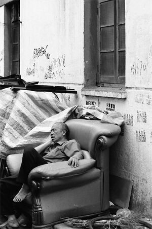 Man taking a nap on sofa in lane