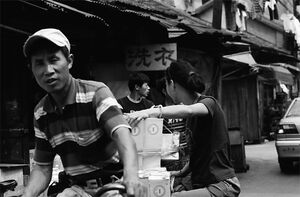 Man casting an eye on camera while pedaling bicycle