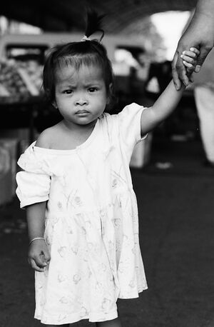 Girl holding mother's hand