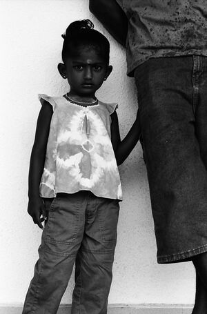 Girl grabbing father\'s trouser