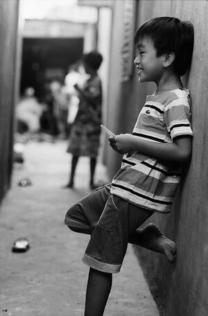 Boy laughing alone in lane