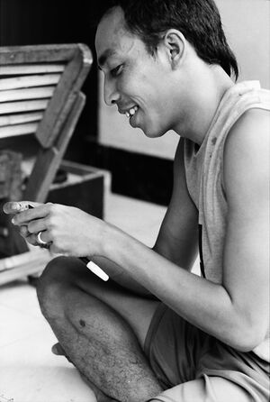 Young painter fixing pen tip
