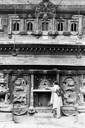Woman standing in front of altar dedicated to Bhairab