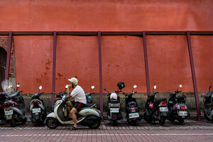 Motorbikes in front of red wall