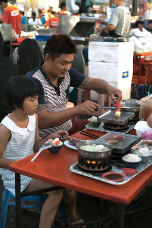 Father and daughter in night market