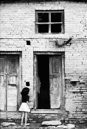 Girl standing in front of door