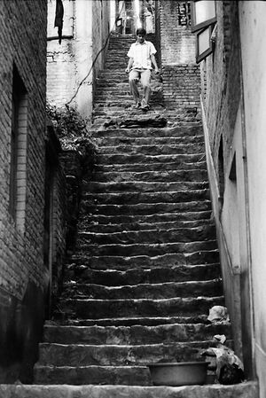Man descending narrow stairway