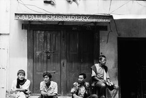 Men hanging out in front of closed store