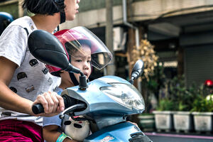 Kid on motorbike with mother