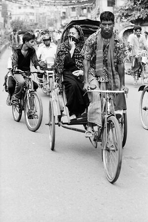 Cycle rickshaw running with passenger