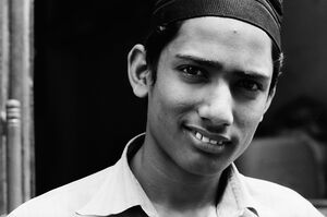 Young man wearing black taqiyah