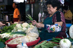 Older woman selling vegetables