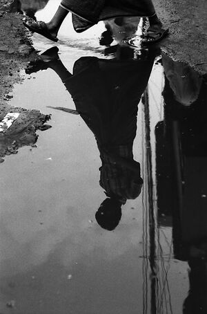 Figure reflected in puddle
