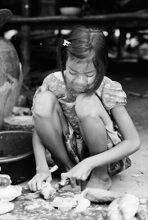 Girl cutting fish