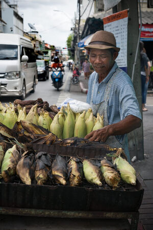 Man selling grilled bananas