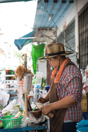 Hatted woman in food stall