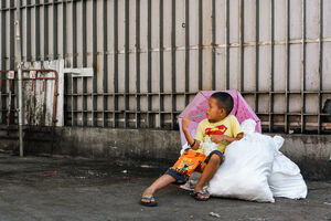 Boy sitting on bags