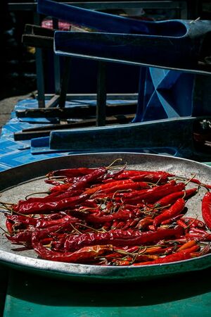 Red peppers being dried in sun in Khlong Toei Market