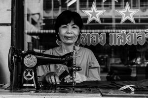 Woman working with old sewing machine