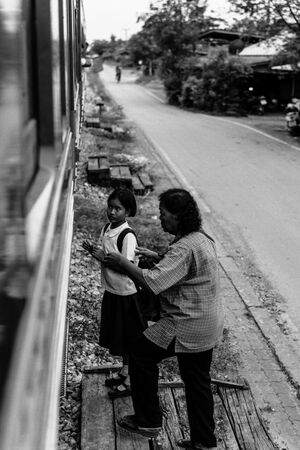 Girl and older woman getting on train