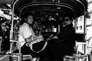 Passengers of Songthaew smiling