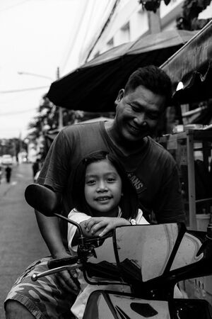 Father and daughter on motorbike