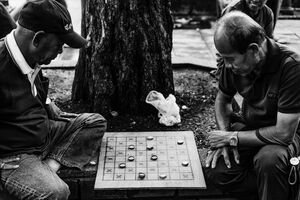 Men playing game on sidewalk