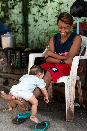 Baby sleeping on father's shins