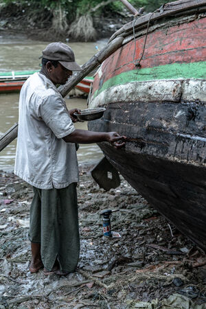 Man repairing fishing boat