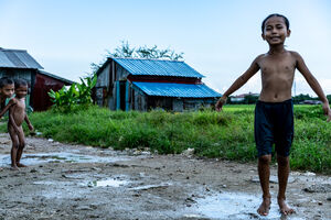 Kids playing around naked on dirt road