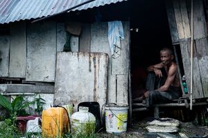Man sitting in shanty house