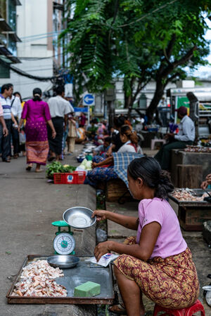 Woman selling shelled shrimps
