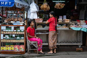 Two women chatting in front of counter