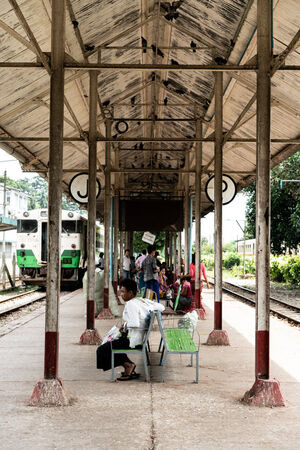 Man resting on platform of Insein station