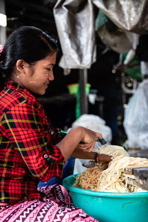 Woman shredding bamboo sprouts