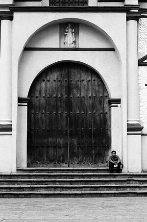 Man sitting in front of closed door