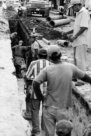 Men standing in long hole