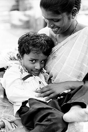 Boy nestling in mother's arm