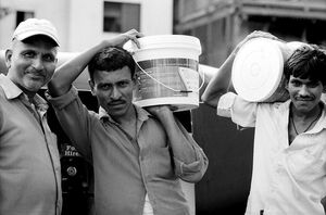 Men carrying container
