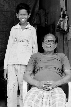 Standing boy and sitting father